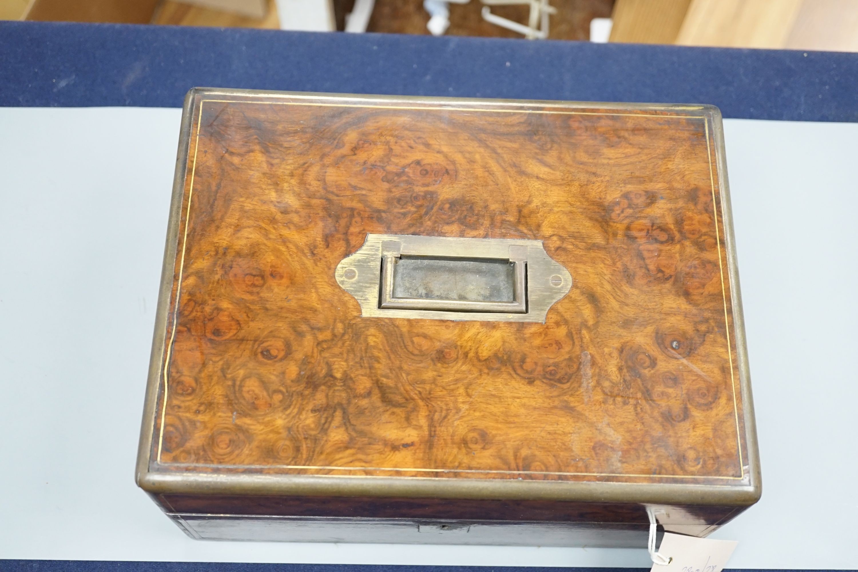 A Victorian brass mounted burr walnut toilet box, fitted with glass jars with electroplated tops, Width 30 cms. Ivory mounted items included